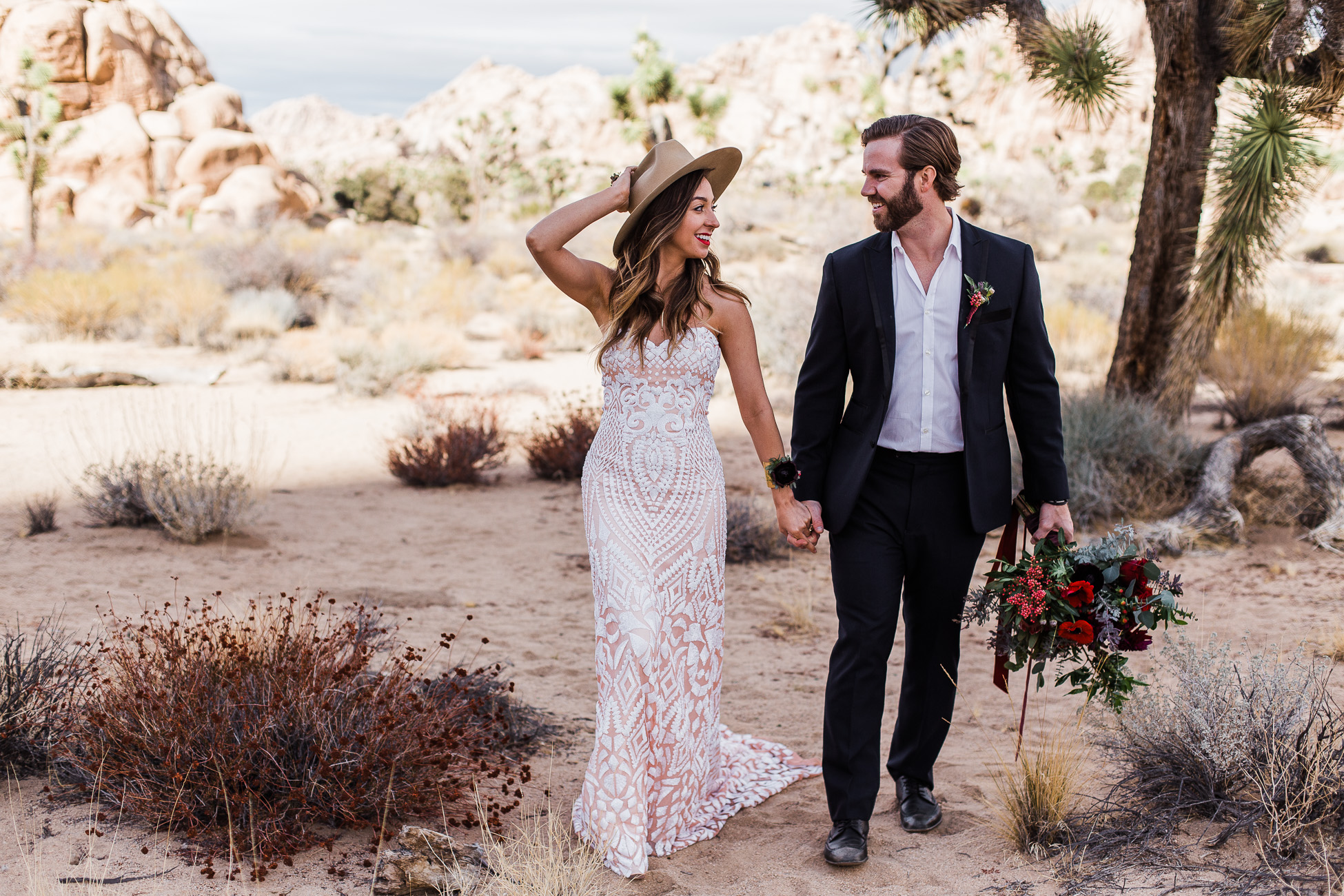 Bride and Groom holding hands in Joshua Tree National Park